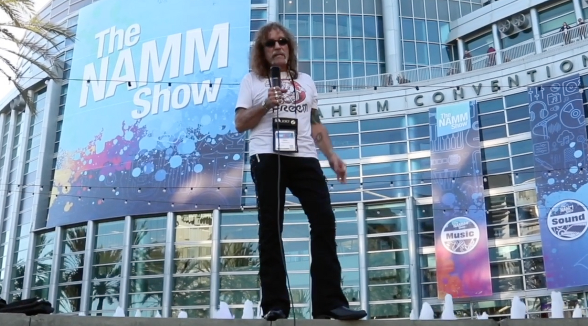 Load video: Al Bane demonstrating custom guitar straps and artist collaborations at NAMM
